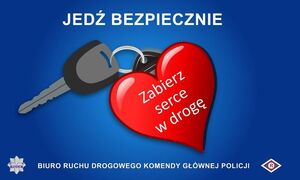 niebieskie tło w centralnej części grafika samochodowy kluczyk z brelokiem w kształcie serca koloru czerwonego i z białym napisem wewnątrz - zabierz serce w drogę. U góry napis jedź bezpiecznie, na dole Biuro Ruchu Drogowego Komendy Wojewódzkiej Policji w Łodzi