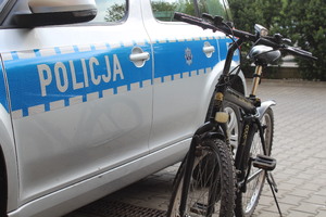 rower stojący przy oznakowanym radiowozie policyjnym
