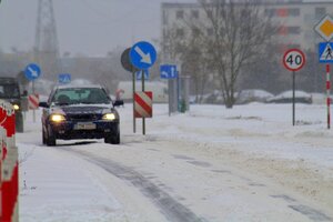 auto jadące po ośnieżonej drodze