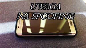 smartfon i naniesiony napis Uwaga na spoofing