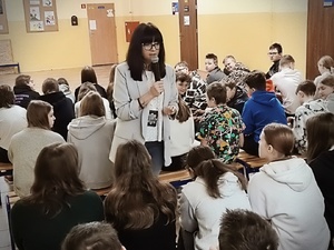 policjantka mówiąc do mikrofonu prowadzi zajęcia z młodzieżą